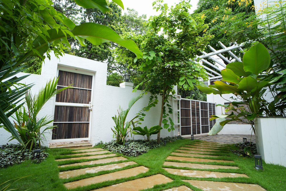 Courtyard garden with a wooden door and stepping stones