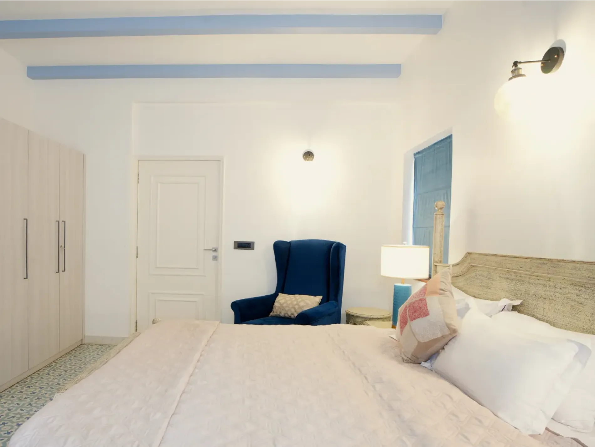 Bedroom with a king bed and wing chair