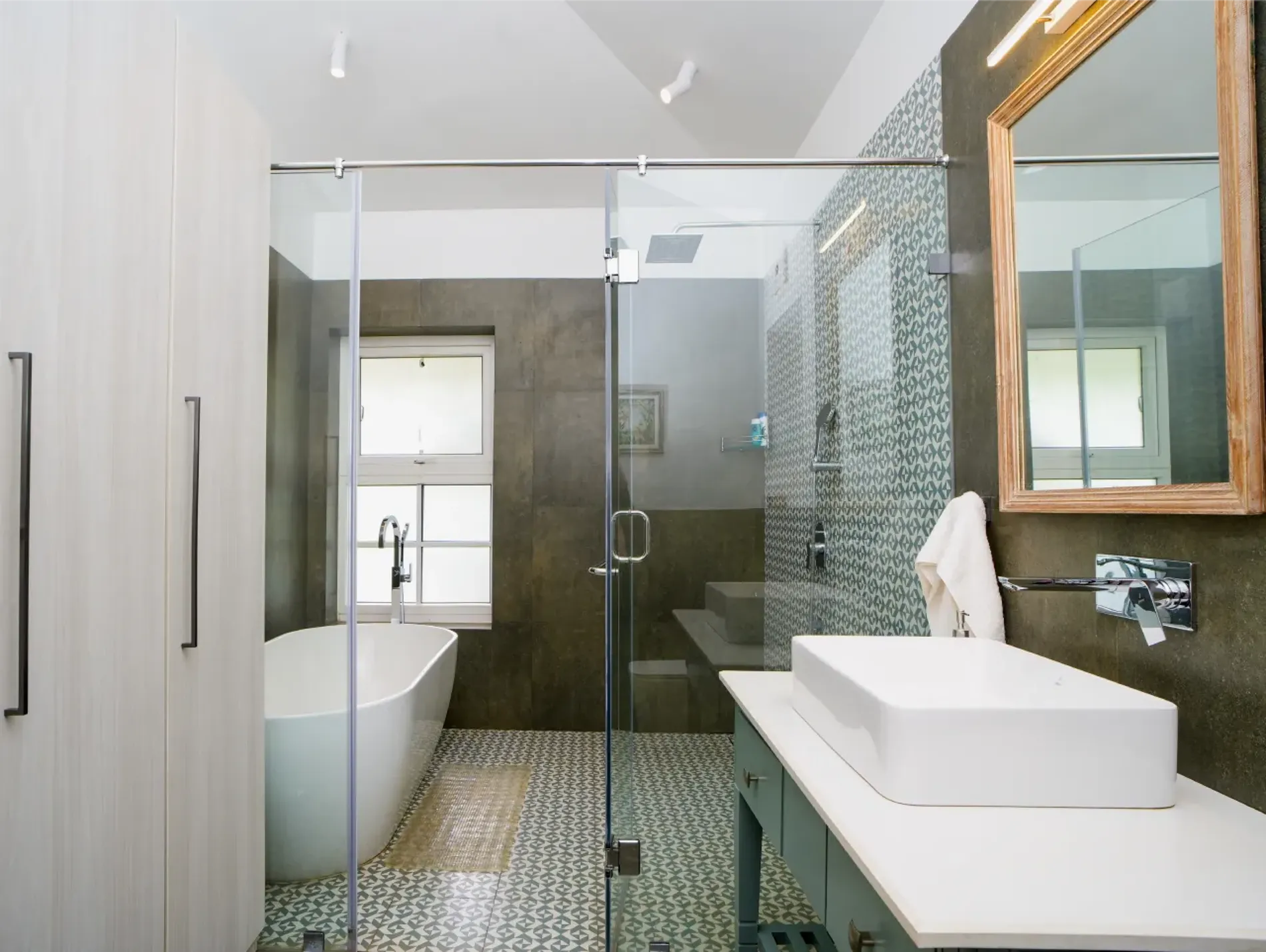 Bathroom with a freestanding bathtub and glass shower