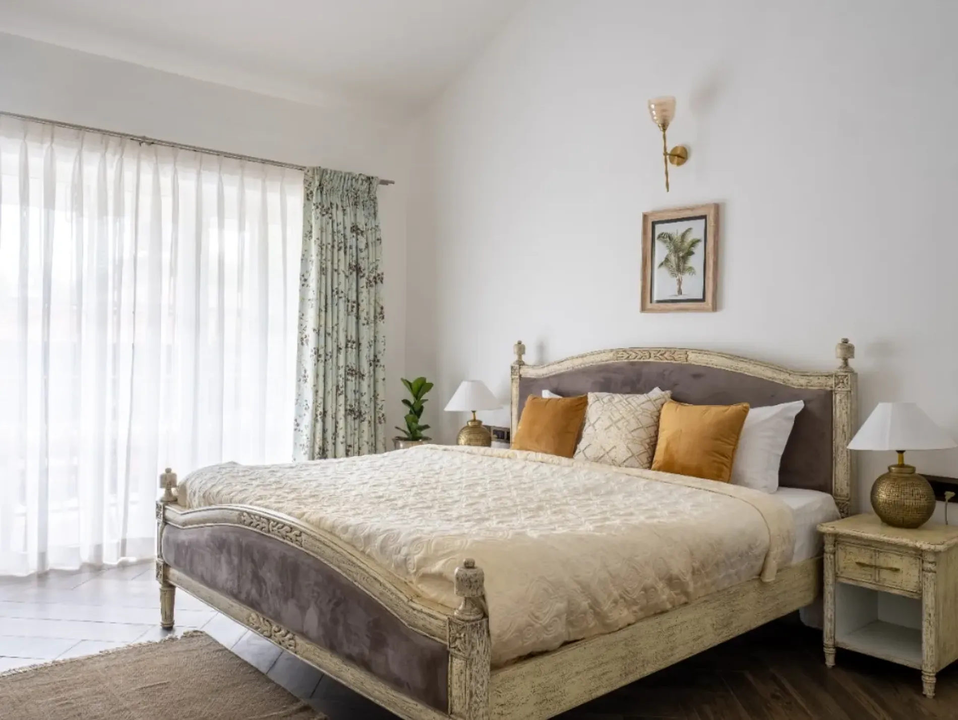Bedroom with a king bed and curtained windows